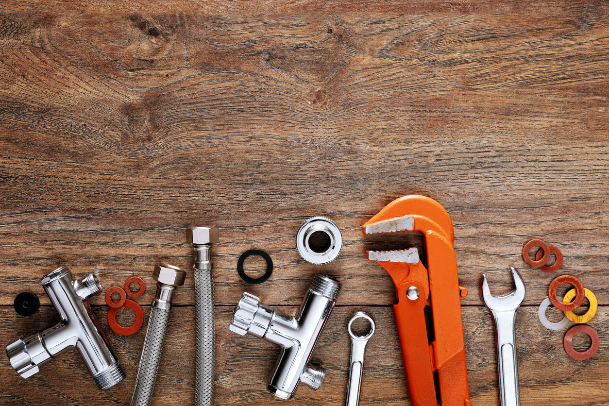 Plumbing Tools on Wooden Table